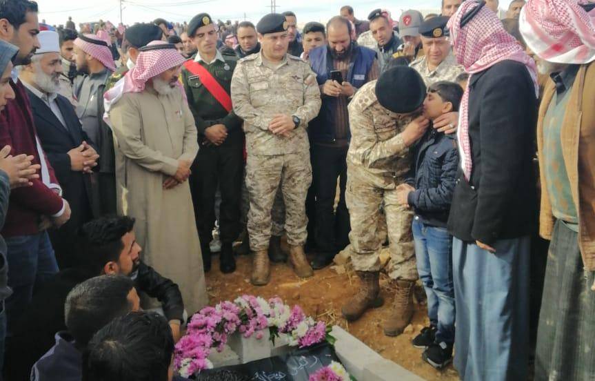 صورة معبرة للعميد علي الدومي وهو يحتضن ابن المرحوم العميد  الجبور اثناء مراسم الدفن