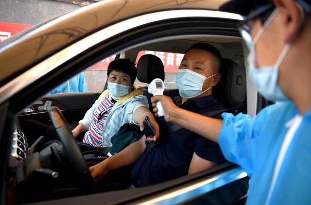 Mass virus testing in Beijing after new cluster triggers lockdowns