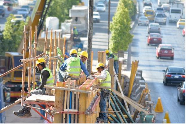 Daily wage workers toil in summer heat