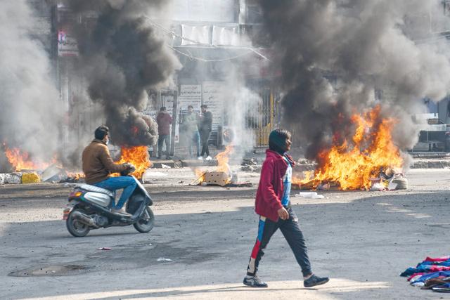 Iraqi policeman shot, dozens wounded in protests