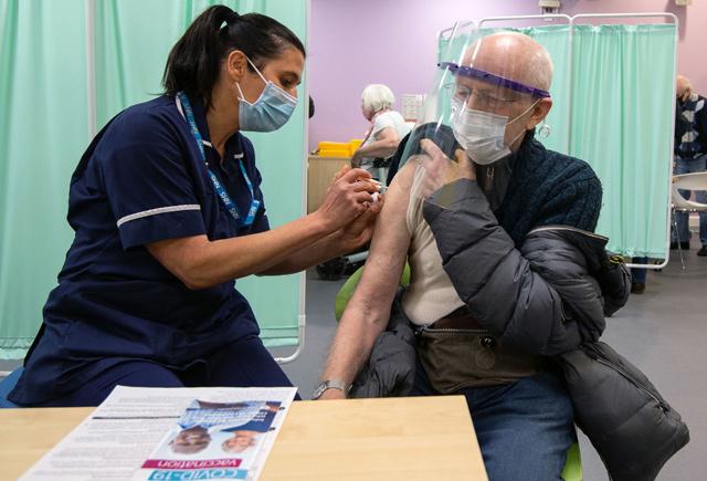 England opens mass vaccination sites as virus spike fears spread