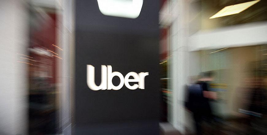 Uber posts profit on onetime gains